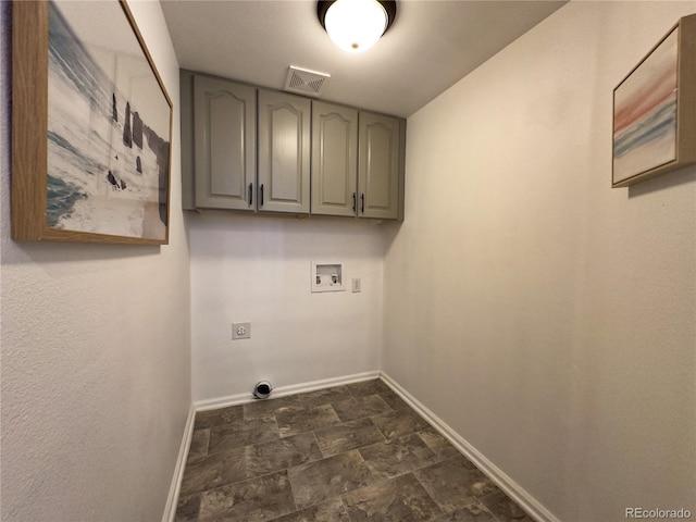 clothes washing area featuring hookup for an electric dryer, cabinets, and washer hookup