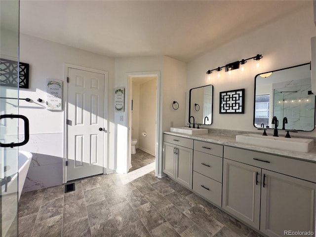 full bathroom with vanity, toilet, and separate shower and tub