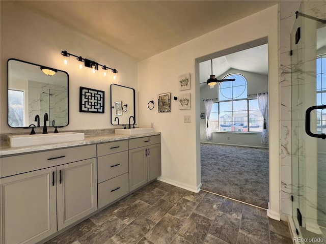 bathroom with a shower with shower door, vanity, lofted ceiling, and ceiling fan