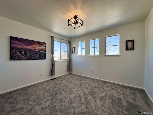 spare room with dark carpet