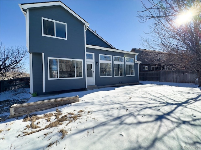 view of snow covered rear of property