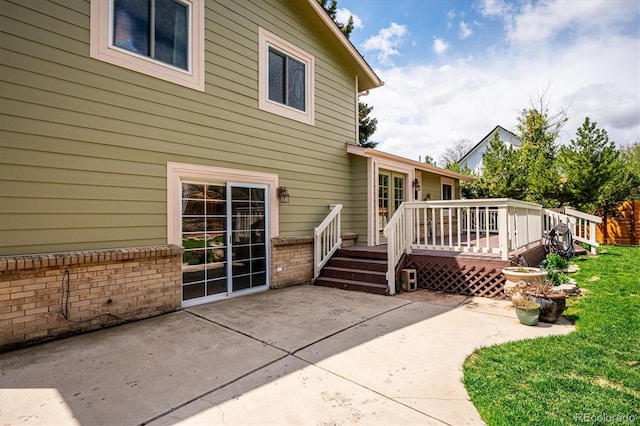 7863 W Quarto Ave, Littleton, CO 80128 - rear view of house with a patio, a deck, brick siding, and a yard