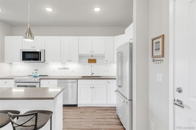 kitchen featuring sink, appliances with stainless steel finishes, and white cabinetry