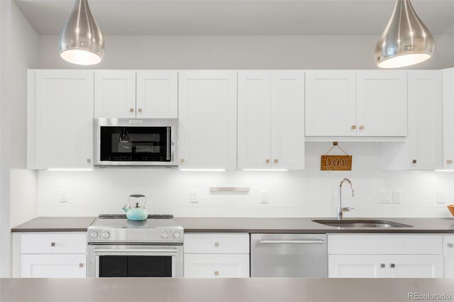 kitchen featuring sink, white cabinetry, and stainless steel appliances