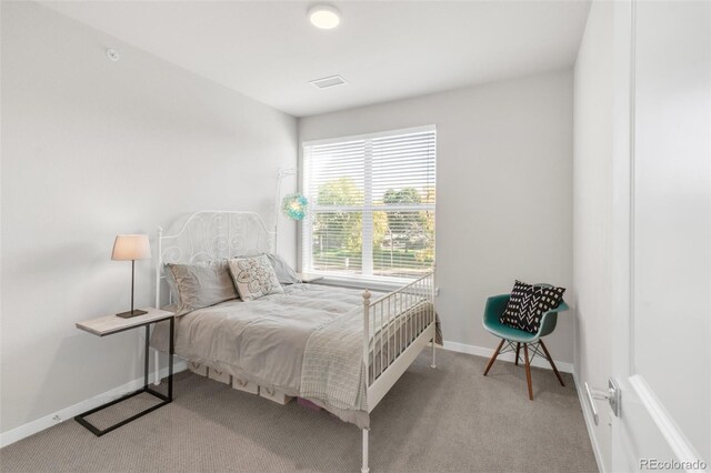 bedroom featuring light colored carpet