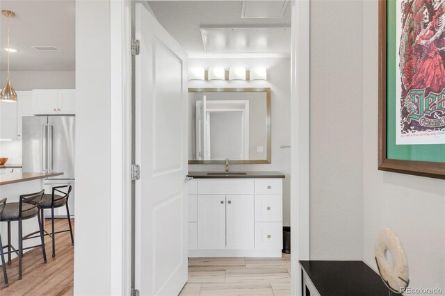 bathroom featuring hardwood / wood-style flooring and vanity