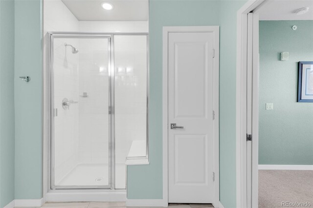 bathroom with a shower with shower door