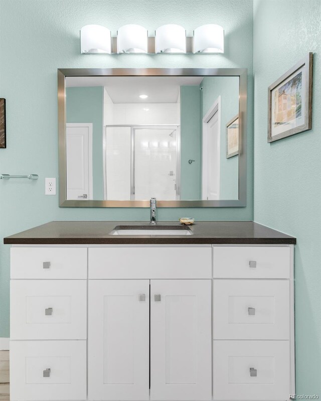 bathroom with vanity and an enclosed shower