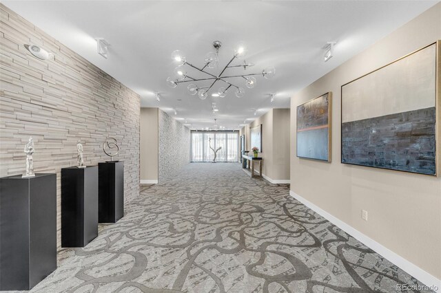 interior space with light colored carpet and a chandelier