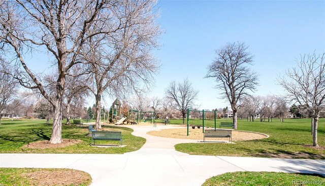 view of property's community with a playground and a lawn