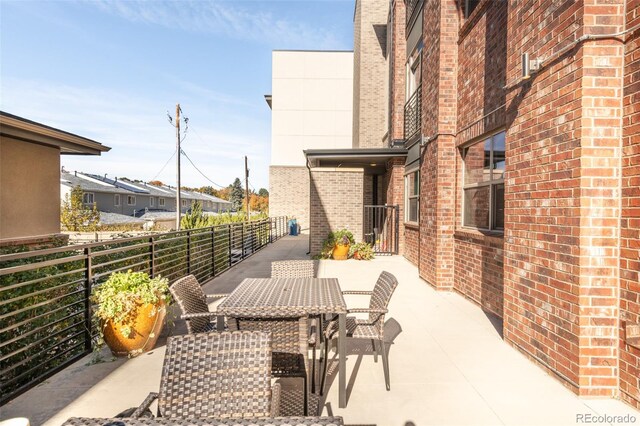 view of patio featuring a balcony