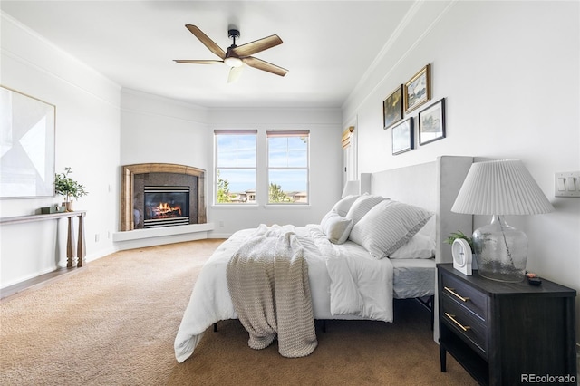 27485 E Nova Pl, Aurora, CO 80016 - carpeted bedroom with ornamental molding, a glass covered fireplace, and ceiling fan