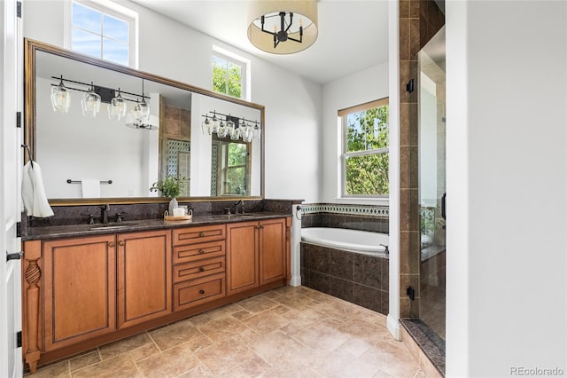 27485 E Nova Pl, Aurora, CO 80016 - full bathroom featuring plenty of natural light, a bath, a shower stall, and double vanity