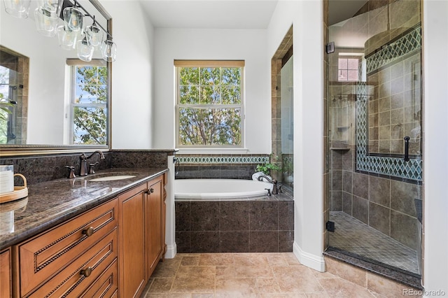 27485 E Nova Pl, Aurora, CO 80016 - full bathroom featuring healthy amount of natural light, vanity, a stall shower, and a garden tub