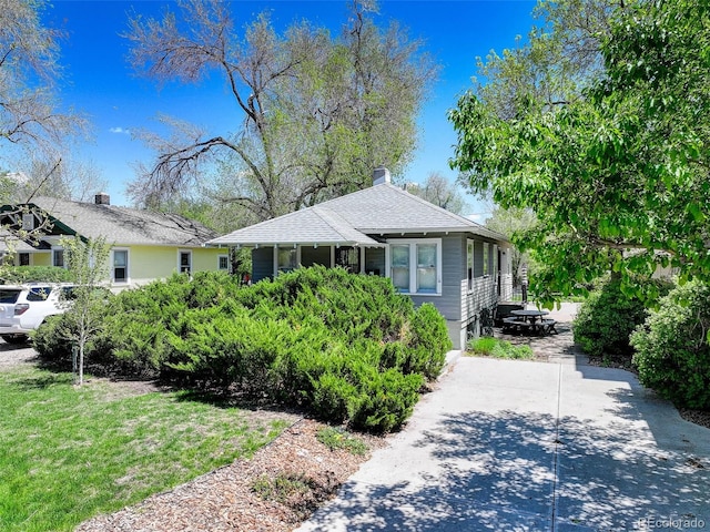 150 S Garfield St, Denver, CO 80209 - view of front of home featuring a shingled roof and a front lawn