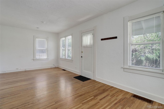 150 S Garfield St, Denver, CO 80209 - foyer with light wood-type flooring, baseboards, and a textured ceiling