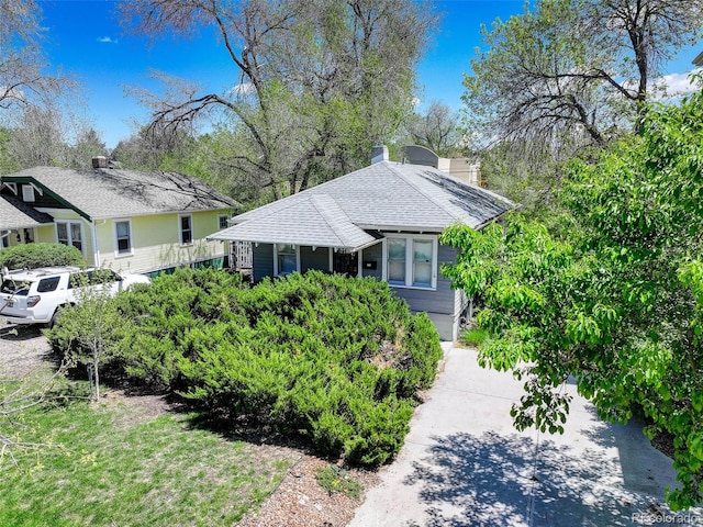 150 S Garfield St, Denver, CO 80209 - view of front of house with a shingled roof and a chimney