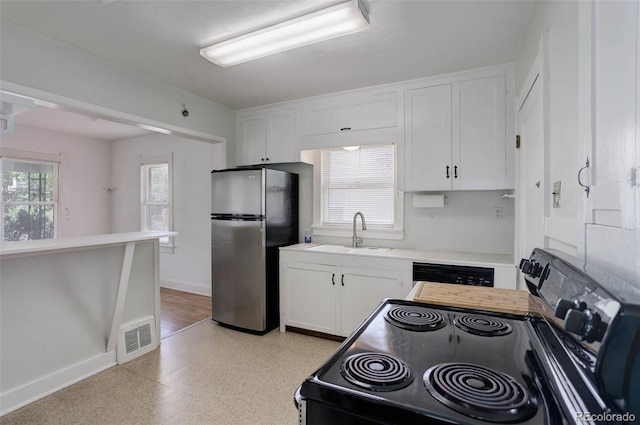 150 S Garfield St, Denver, CO 80209 - kitchen with freestanding refrigerator, a sink, black electric range oven, and white cabinetry