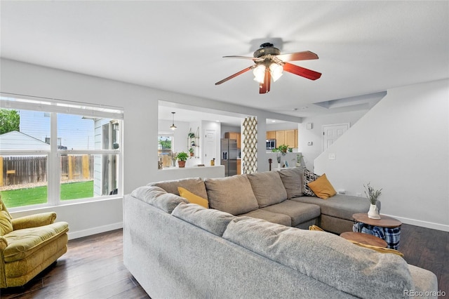 7868 Downing St, Denver, CO 80229 - living room featuring baseboards, a ceiling fan, and wood finished floors