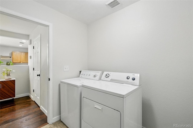7868 Downing St, Denver, CO 80229 - laundry area with washing machine and dryer, wood finished floors, and baseboards