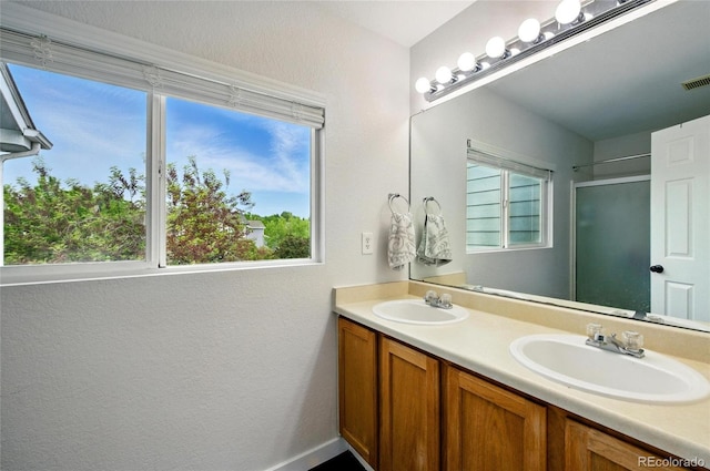 7868 Downing St, Denver, CO 80229 - bathroom with double vanity and an enclosed shower
