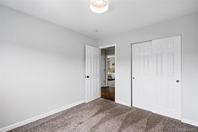 7868 Downing St, Denver, CO 80229 - unfurnished bedroom featuring dark colored carpet, baseboards, and a closet