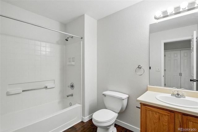 7868 Downing St, Denver, CO 80229 - bathroom featuring wood finished floors, toilet, vanity, bathing tub / shower combination, and baseboards