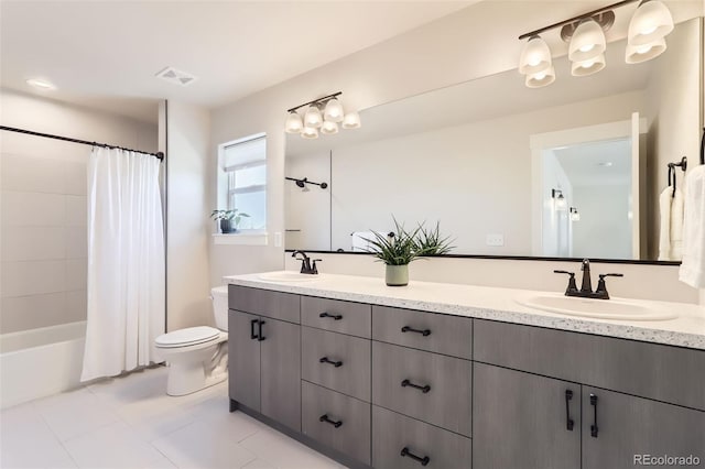 full bathroom featuring vanity, tile patterned floors, shower / bath combo with shower curtain, and toilet