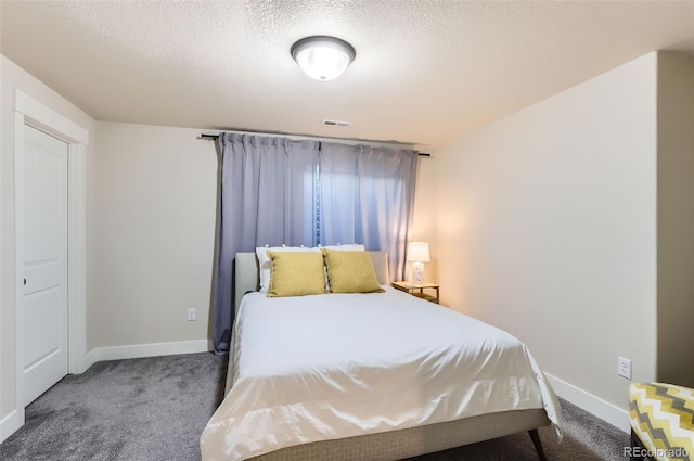 carpeted bedroom featuring a textured ceiling