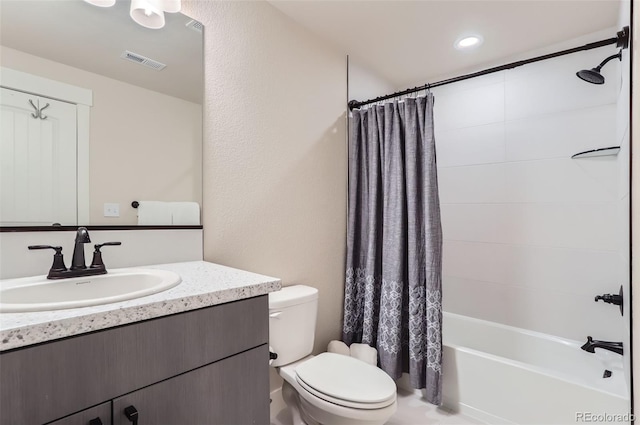 full bathroom with shower / tub combo with curtain, vanity, and toilet