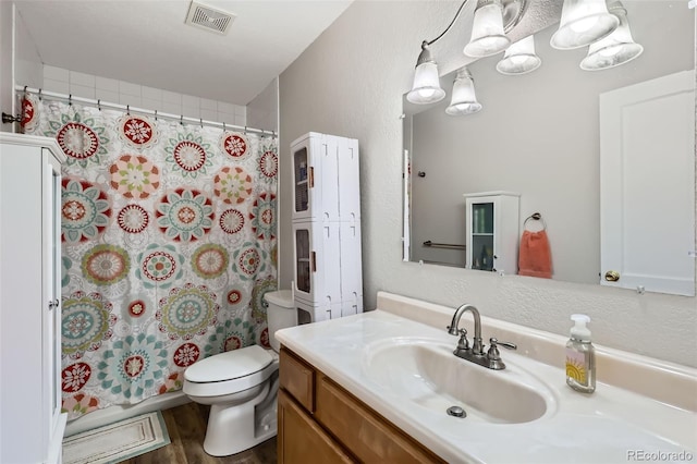 1011 Uvalda St, Aurora, CO 80011 - bathroom featuring vanity, curtained shower, and wood finished floors