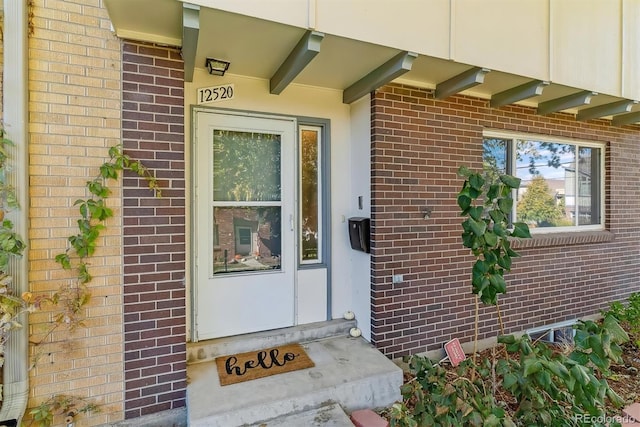 entrance to property with brick siding