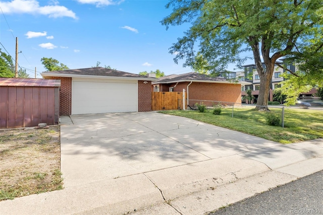 2101 Youngfield St, Golden, CO 80401 - ranch-style home with brick siding, a garage, concrete driveway, and an outdoor structure