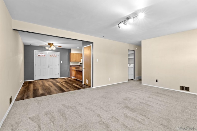 2101 Youngfield St, Golden, CO 80401 - spare room featuring washer / dryer, a ceiling fan, and dark colored carpet
