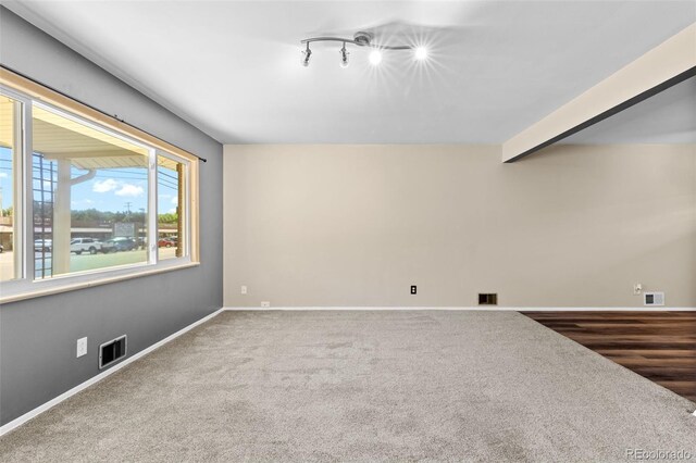 2101 Youngfield St, Golden, CO 80401 - unfurnished living room featuring carpet flooring and rail lighting