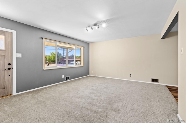 2101 Youngfield St, Golden, CO 80401 - unfurnished living room with rail lighting and carpet flooring