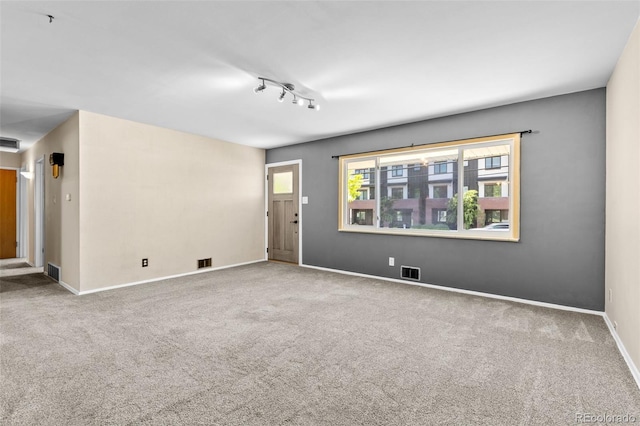 2101 Youngfield St, Golden, CO 80401 - unfurnished living room with healthy amount of natural light, carpet flooring, and track lighting