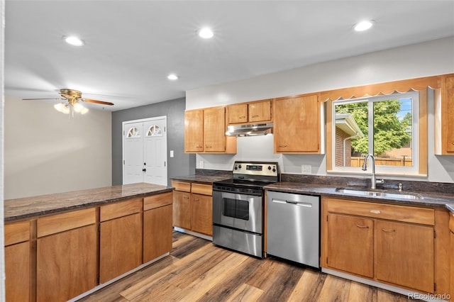 2101 Youngfield St, Golden, CO 80401 - kitchen with appliances with stainless steel finishes, under cabinet range hood, wood finished floors, ceiling fan, and recessed lighting