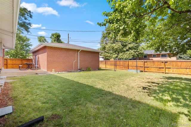2101 Youngfield St, Golden, CO 80401 - fenced backyard featuring a patio area and an outdoor structure