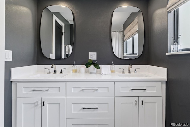 full bath with double vanity and a sink