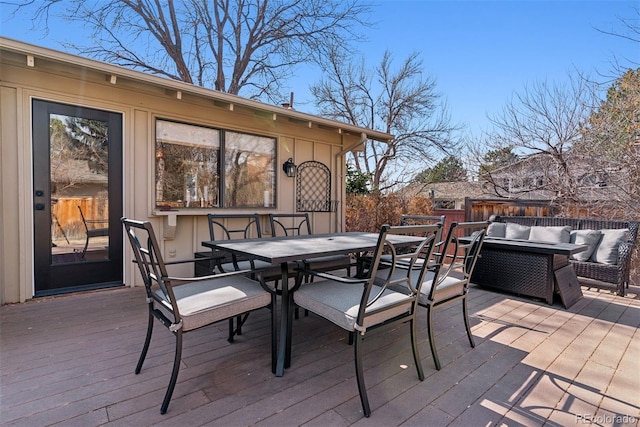 wooden terrace featuring outdoor dining space and outdoor lounge area