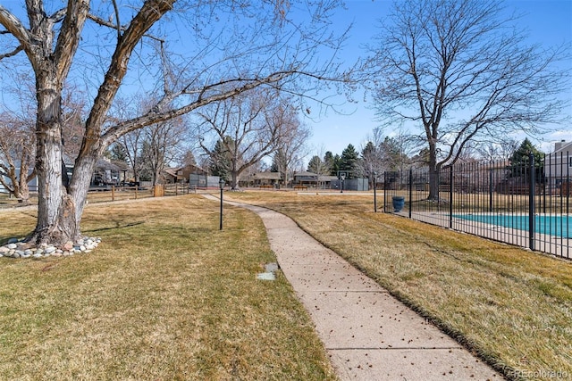 view of yard with a fenced in pool and fence