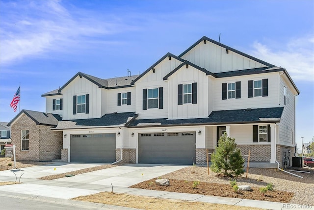 view of front of property with a garage and central AC unit