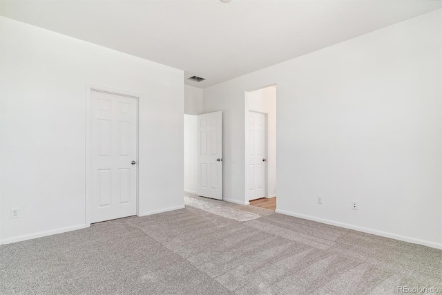 empty room with light colored carpet