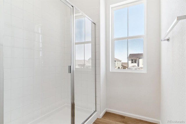 bathroom with hardwood / wood-style floors and walk in shower