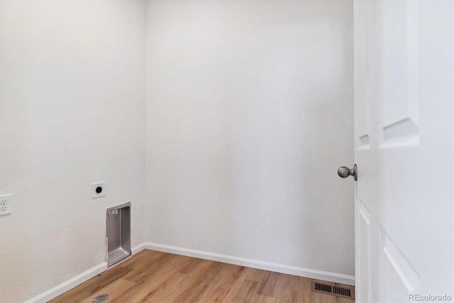 washroom with light hardwood / wood-style flooring and hookup for an electric dryer