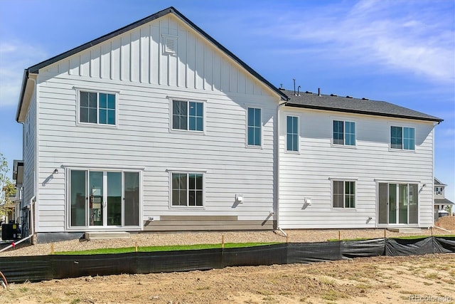 rear view of house featuring central AC