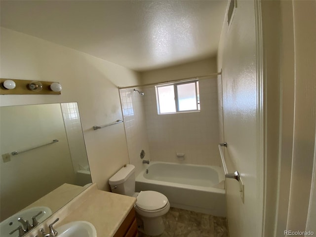 full bathroom with tile patterned floors, toilet, vanity, and tiled shower / bath