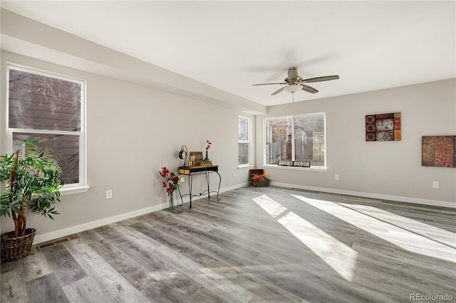 spare room with ceiling fan and light wood-type flooring