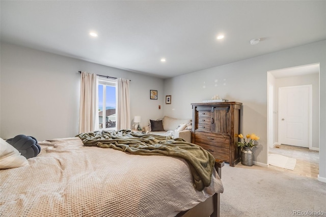 bedroom featuring recessed lighting, light colored carpet, and baseboards